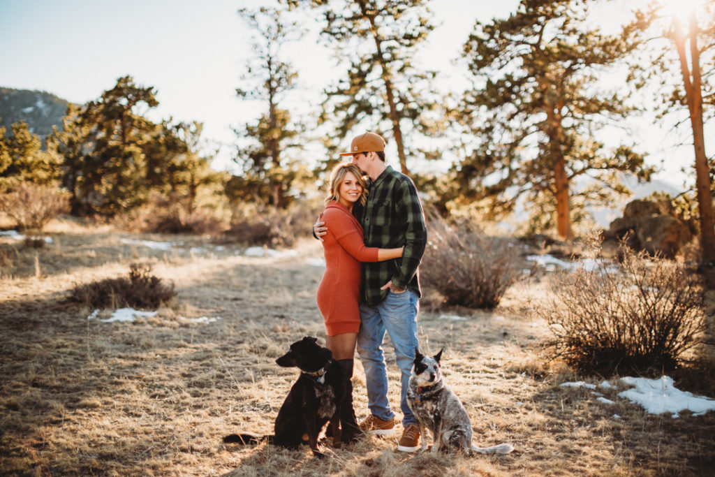 couple and dogs embrace in Estes Park Colorado
