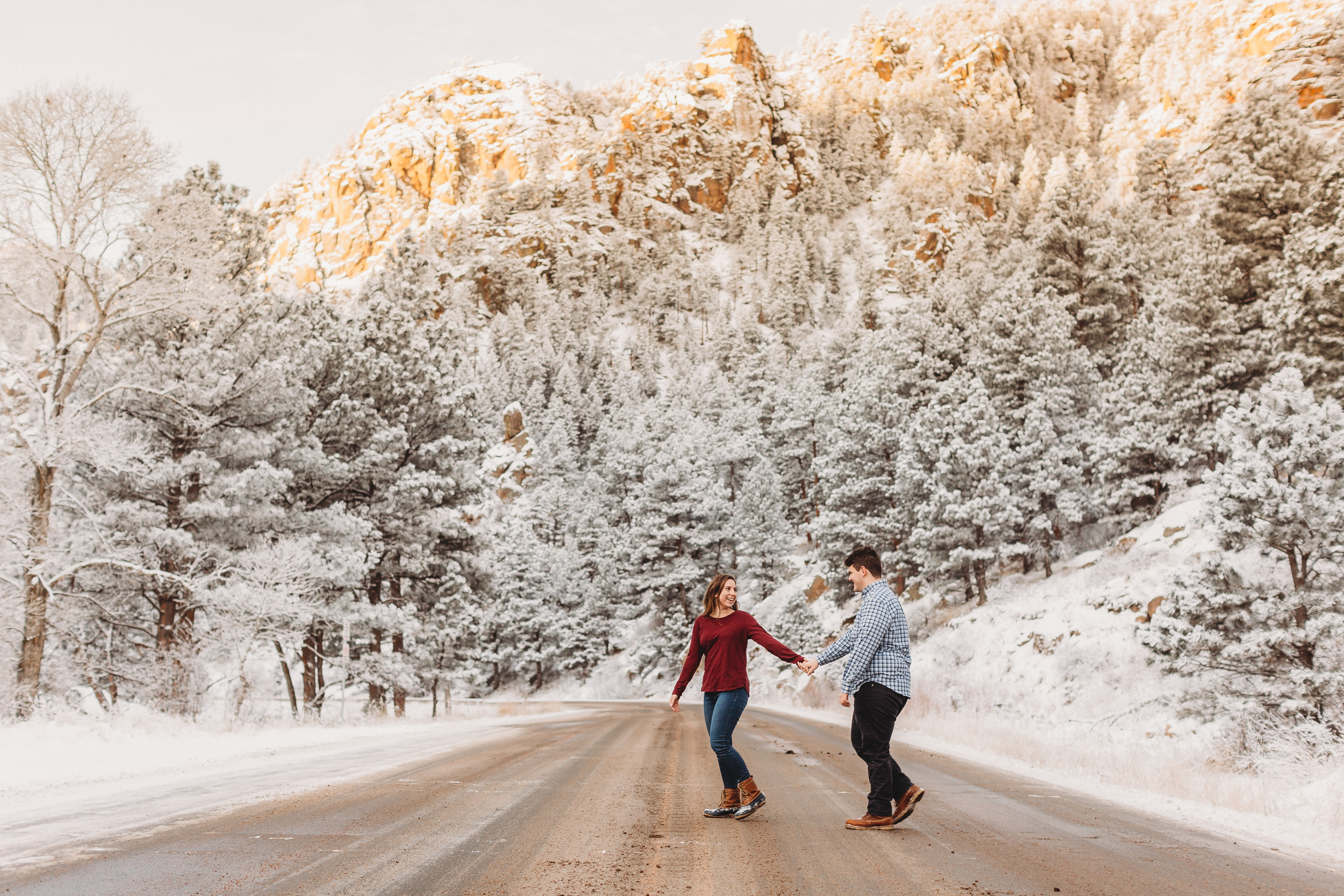 couple walking across canyon in Lyons Colorado
