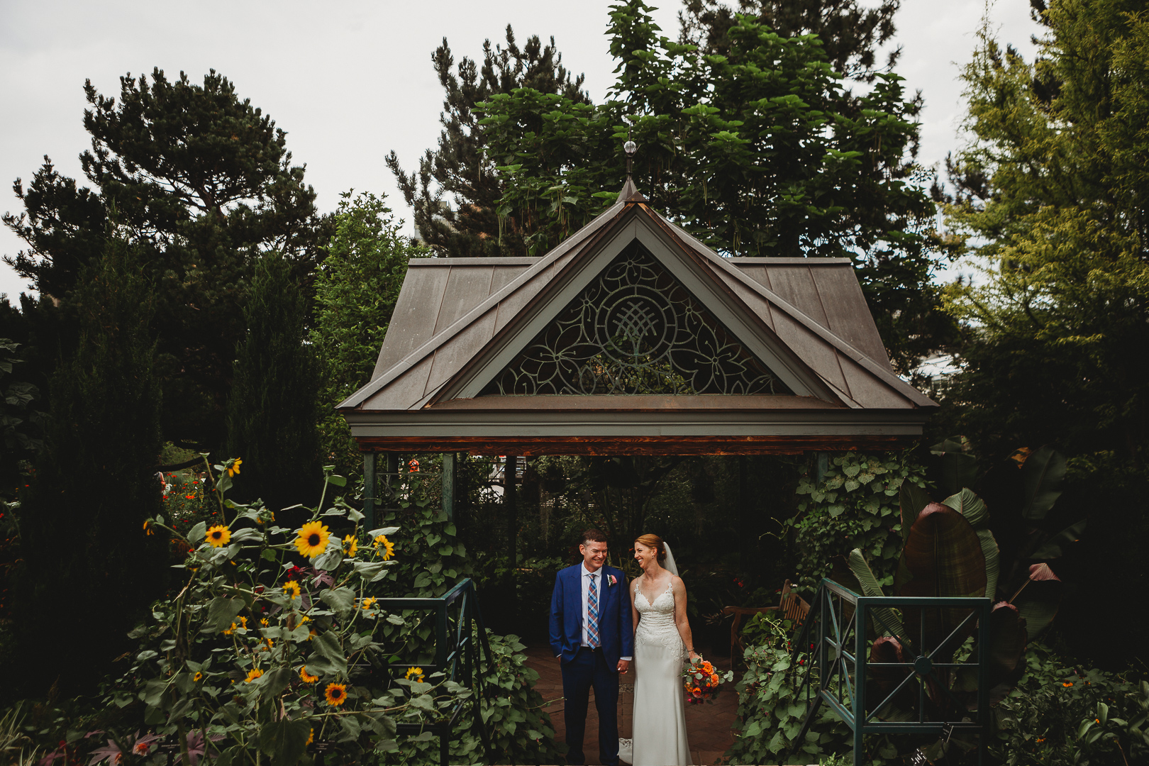 bride and groom laugh at Denver botanic gardens