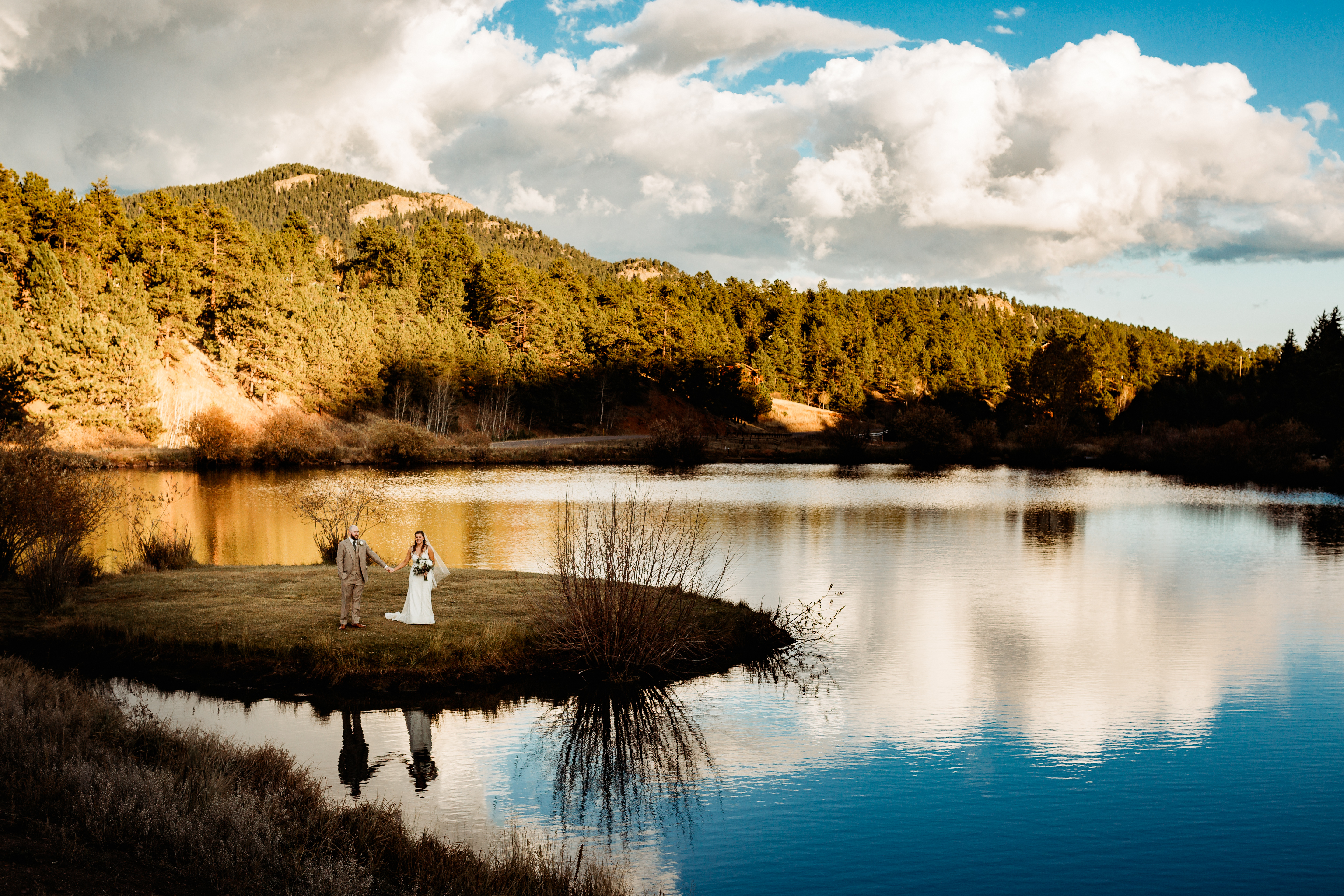 bride and groom stand near lake at Wedgewood Mountain View ranch