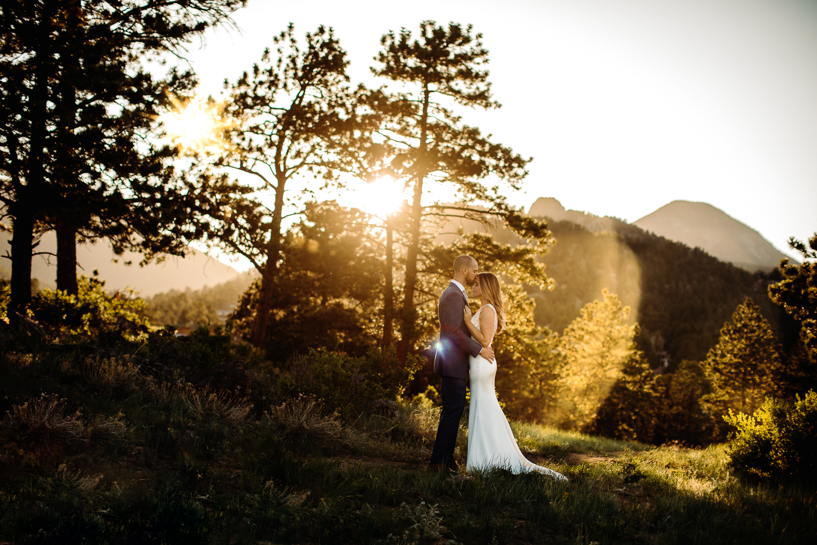bride and groom embrace at an open space in Estes Park Colorado