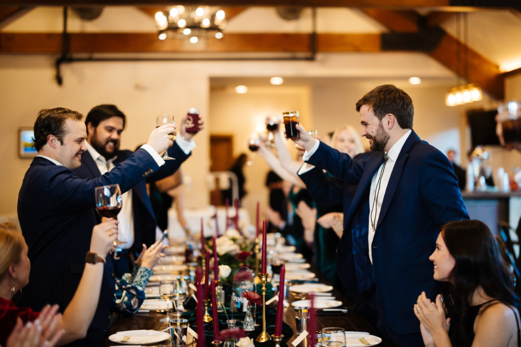 Groomsmen celebrate the bride and groom with a toast at The Landing in Estes Park.
