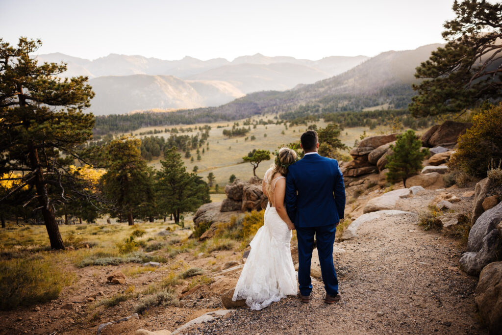 bride and groom admire the view at 5 mile curve in Rocky Mountain National Park